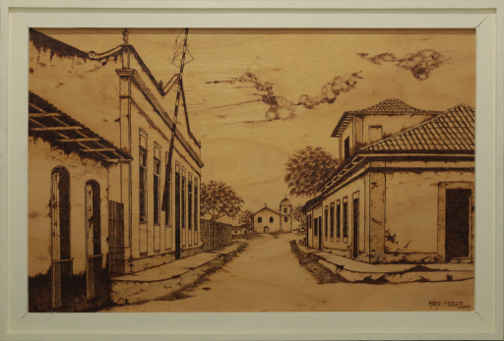 Macapá Histórica II | 2021 | Pirogravura | 100 cm x 80 cm 

As obras foram feitas com aproveitamento de tampo de caixote usando o conceito de Arte Ecológica, ambas fazem parte da série MACAPÁ HISTÓRICA. São obras que enfatizam a história e identidade da cidade de Macapá, preservando a memória ao representar a arquitetura de outrora, resgata um pouco da história da cidade e preserva um fragmento de história. Ela valoriza a arquitetura como testemunho da formação cultural do lugar, lembrando que as ruas, igrejas e casas guardam marcas de vidas, encontros, deslocamentos e memórias coletivas.